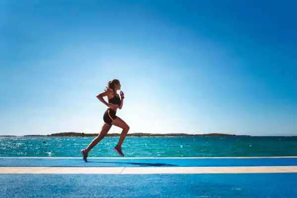 Woman running showing strong leg muscle Bletchley